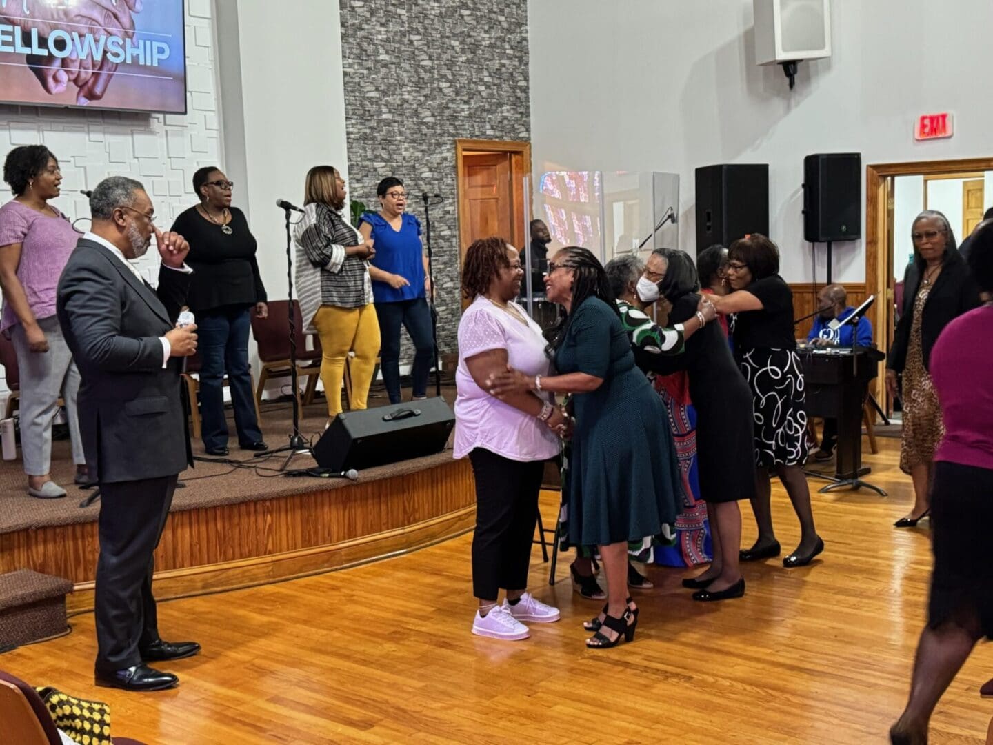 A group of people dancing in front of a microphone.