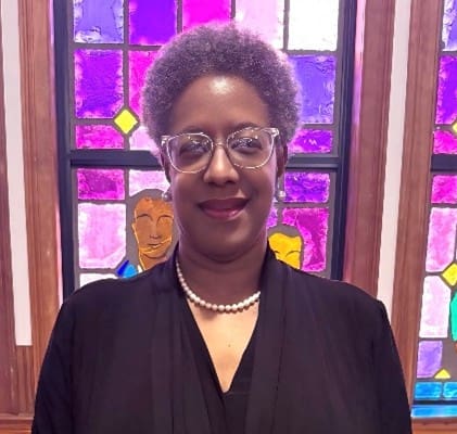 Woman with glasses and pearls in stained glass