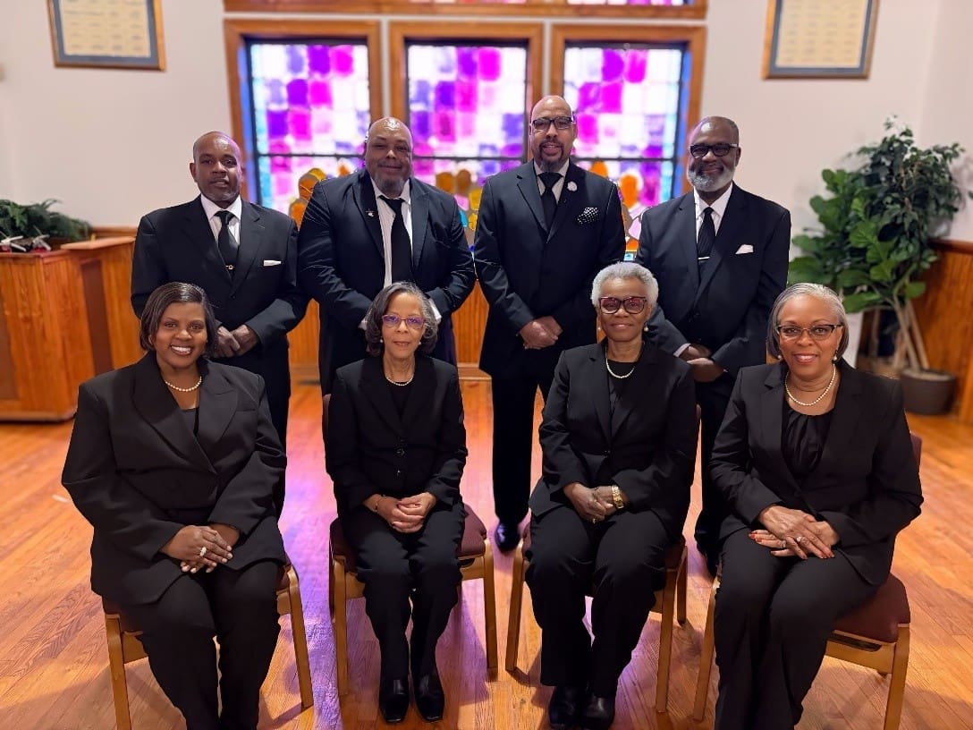 Group of people in black suits at church