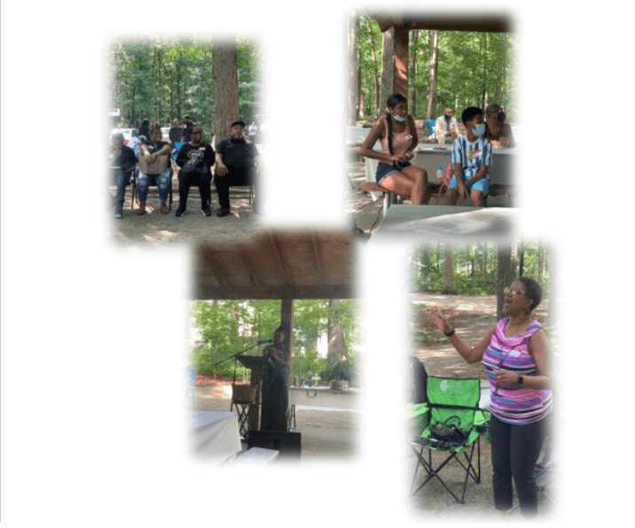 Outdoor community gathering with speaker and attendees
