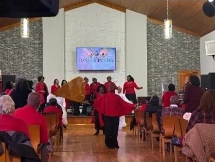 Church choir in red robes performing during service