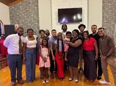 Large group of smiling people posing indoors