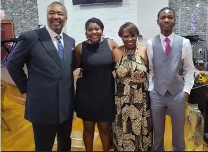 Four people posing in formal attire