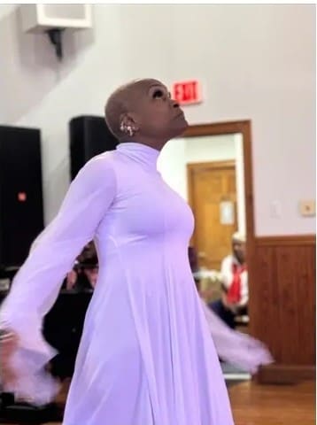 Woman in lavender dress looking upward